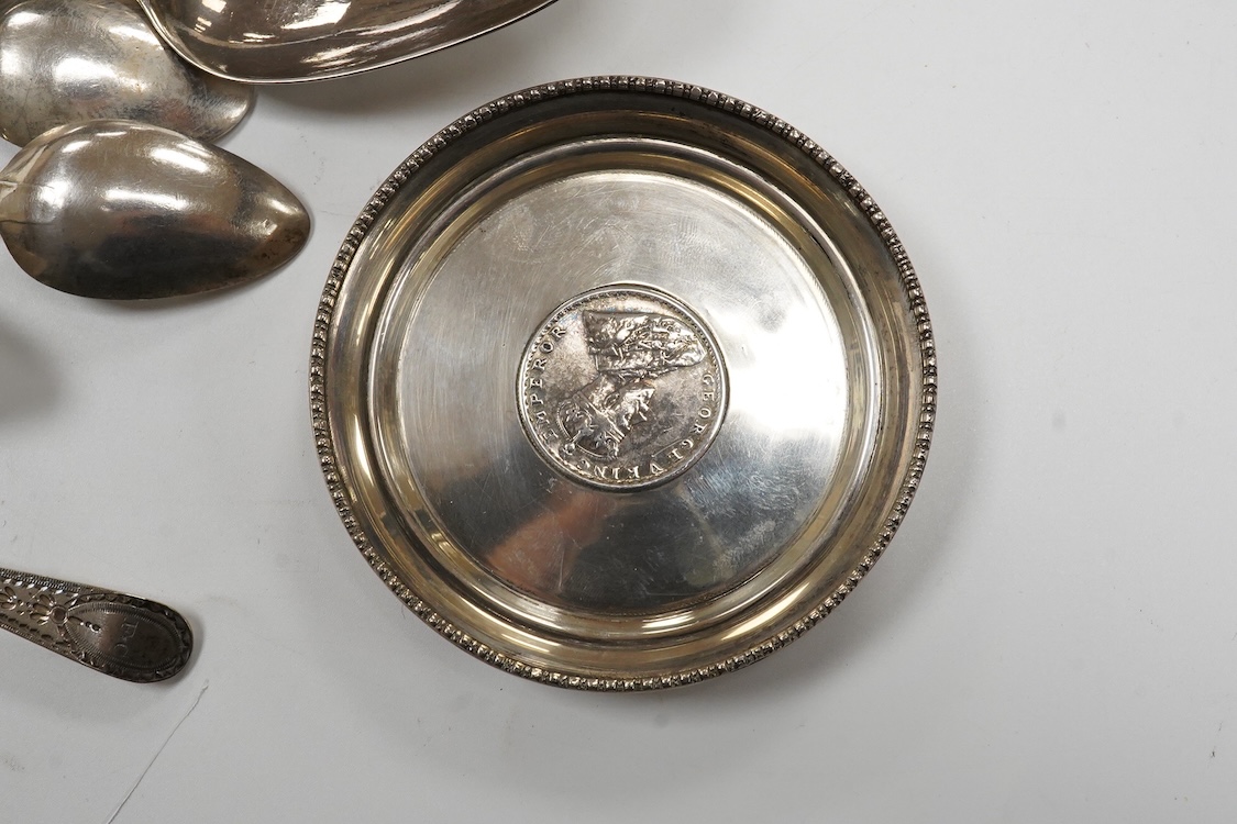 A collection of small silver and white metal items, including an Indian Hamilton & Co small dish, the centre inset with 1840 one rupee coin, one other white metal dish, two modern silver mounted napkin rings, fourteen as
